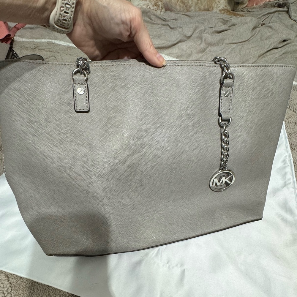 Gray leather Micheal Kors purse with metal details
